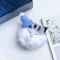 Cute plush cat phone socket with blue knit hat and pom-pom detail on aesthetic background - Blue Hat Grey Striped Cat Style