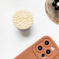 Supporto per telefono minimalista in rattan intrecciato beige con base lavanda su bianco - Albicocca