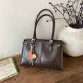 Borsa a spalla retrò in ecopelle marrone scuro con ciondoli su superficie in legno - Con Ciondolo / Marrone