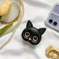 Detailed close-up of a 3D cute black cat phone grip on a decorative aesthetic background - 3D Black Cat Bracket - Gold Eyes