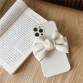 Creamy white iPhone case with a large faux leather bow on a vintage book - Apricot / iPhone 13 Pro