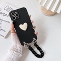 Detail of black iPhone case featuring a 3D cream heart and chunky chain strap handle - Black (with 3D Heart + Black Chain) / iPhone 13 Pro