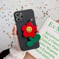 Black iPhone case with vibrant red plush sunflower charm and iconic yellow smiley face - iPhone 12 Pro Max / Black