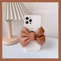 Elegant cream iPhone case featuring a large caramel leather bow on a textured matte surface - Brown / iPhone 13 Pro