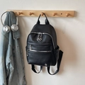 Sleek black pebble leather backpack for women with silver zippers and metal logo detail - Black