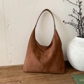 Classic vintage brown suede hobo tote bag for women shown in a minimalist aesthetic setting - Brown