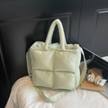 Chic light green quilted puffer tote bag with adjustable strap in a minimalist style - Green