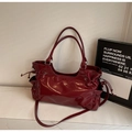 Detail of burgundy patent leather tote bag with drawstring closure and glossy finish - Burgundy