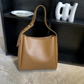 Retro large capacity brown leather bucket bag set with wide shoulder strap on a shelf - Brown