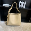 Minimalist beige bucket bag set with wide shoulder strap on marble floor display - Khaki