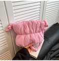 Detailed shot of pink quilted cloud bag featuring soft padded texture and knot details - Pink