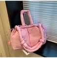 Detail of pink quilted tote bag showing puffy nylon texture and padded handles - Pink