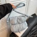 Light blue quilted puffer cloud bucket bag with minimalist knot shoulder strap detail - Haze Blue
