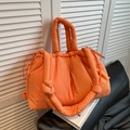 Bright orange padded bucket bag with quilted nylon texture and knotted shoulder strap - Orange
