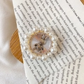 Macro view of a gold rabbit phone grip with pearl border and star details - Star Rabbit / White