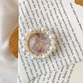Macro shot of an elegant pearl-framed phone grip featuring a sparkling rhinestone butterfly - Rhinestone Butterfly / White