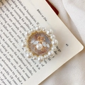 Macro shot of vintage gold bee phone grip with pearls and rhinestones on a book - Small Pearl Bee / White
