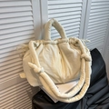 Minimalist cream white quilted bucket bag featuring a soft ruched texture and knotted strap - White