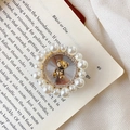 Detail of cute golden bear phone grip with sparkling rhinestones and white pearls - Mini Bear / White