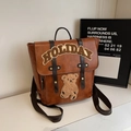 Mochila vintage de cuero marrón con texto Holiday y parche de oso estilo colegio - Marrón