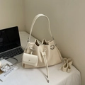 Minimalist beige drawstring bucket bag with round metal ring and matching small pouch - Off-white