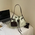 Minimalist sage green bucket bag with drawstring closure and contrasting brown strap - Light Green