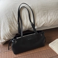 Chic black underarm tote bag with MUTING logo and adjustable straps on white linen - Black