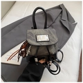 Detail of vintage denim and leather backpack with silver ball drawstring and tassel charm - Black With Pendant