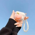 Clear AirPods Pro case with 3D peach design and elegant white pearl lanyard strap - Transparent Squeeze Peach (With Pearl Bracelet) / AirPods 1/2