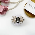 Close-up of luxury rhinestone phone socket with grey gem and white faux fur detail - Black