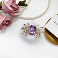 Macro detail of luxury rhinestone crystal accessory with purple gem and soft white fur - Purple