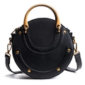 Circular black matte leather crossbody bag with curved gold handle and rivet details - Black