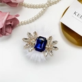 Folding phone socket with large blue gem and white faux fur pompom embellishment - Blue