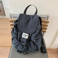 Blue and black plaid drawstring backpack with Aoneshe world brand label on a chair - Dark Grey Grid