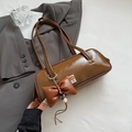 Brown glossy cylinder underarm bag with long strap and oversized leather bow charm - Brown (With Pendant)
