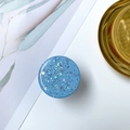 Macro shot of starry blue phone socket with glitter moon and star sequins on white background - Starry Sky Grip - Blue