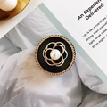 Macro shot of camellia phone stand with gold finish and white pearl inlay details - No.15 Camellia - Black