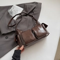 Detail of dark brown glossy PU leather crossbody bag with multiple utility pockets - Brown