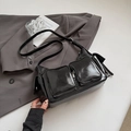 Glossy black multi-pocket utility shoulder bag with adjustable strap and silver hardware - Black