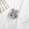 Close-up of grey plush rabbit phone stand with soft texture and embroidered details - Gray