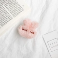 Close-up of pink plush bunny ear phone grip with soft fur and embroidered sleepy eyes - Pink