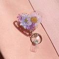 Detailed macro of heart-shaped resin badge reel with purple dried flowers and gold leaf - Purple White Dried Flower Style (2)
