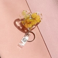 Detail of heart-shaped resin badge reel with real dried flowers and gold leaf accents - Yellow Petal Style (4)