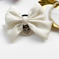 Cream satin bow phone socket grip with golden heart pendant and pearl detail - White