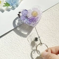 Detail of heart-shaped retractable badge reel with real purple dried flowers in resin - Glitter Purple Flower