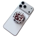 Magnetic phone grip with red and white marble shell texture on a white smartphone - Cow