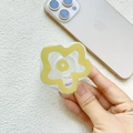 Detail of yellow flower phone grip holder showing acrylic petal design on a gold smartphone - Earth Yellow Flower