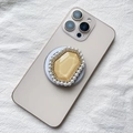 Close-up of luxury Magsafe phone socket with pearl rim and gold diamond crystal gem - Orange Pearl Border