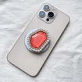 Detail of MagSafe phone grip featuring coral resin stone with pearls and gold rhinestones - Red with Pearl Border