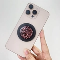 Detail of MagSafe phone grip with gold foil and purple sequins on a pink smartphone - Magnetic Stand / Pink Foil (Black Base)